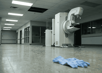 - VeyrZest.com MRI scanner in a quiet hospital hallway, with blue scrubs lying on the floor in the foreground.