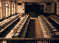 Historic computer lab with rows of beige CRT monitors and keyboards in a grand arched-room setting