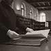 Need_a_picture_of_a_IMAGE_PROM_Nano_Banana_79469 - VeyrZest.com Person in scholarly robe with white gloves turning pages of a thick bound book in a library.