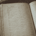 - VeyrZest.com Open antique dictionary with Arabic entries, held by a left hand.