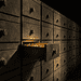 - VeyrZest.com Row of old metal drawers in a vault with one drawer pulled out, revealing glowing gold coins inside.