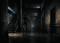Tall black humanoid robot stands in a dim, industrial hallway with rails and a stairwell to the left.