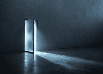 Open metal door emitting a cool blue glow into a dark, empty room.